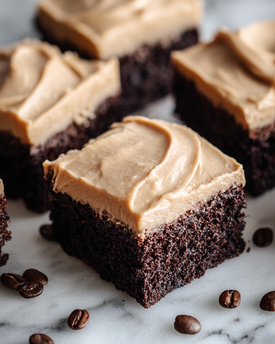 This image shows several square pieces of chocolate brownies, each topped with one thick, smooth layer of light brown frosting. The brownies have a dark, rich, and slightly crumbly texture, while the frosting layer on top is creamy and swirled gently with soft peaks. The pieces are arranged closely together on a surface with a white marbled texture, with a few coffee beans scattered around for decoration. The focus is sharp on the front piece, showing detailed texture in both the brownie and frosting. photo taken with an iphone --ar 4:5 --v 7