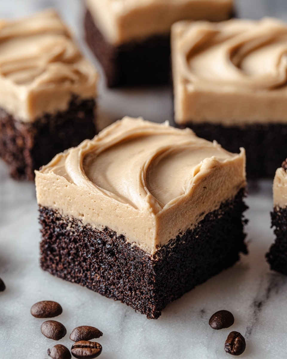 The image shows close-up squares of a two-layer dessert on a white marbled surface. Each square has a bottom layer of dark, rich, crumbly chocolate cake, and a thick top layer of smooth, creamy light brown frosting with gentle swirls and a soft texture. The edges of the frosting are clean but slightly uneven, showing a natural spread. Coffee beans are scattered around the squares, adding a dark brown contrast to the scene. Photo taken with an iphone --ar 4:5 --v 7