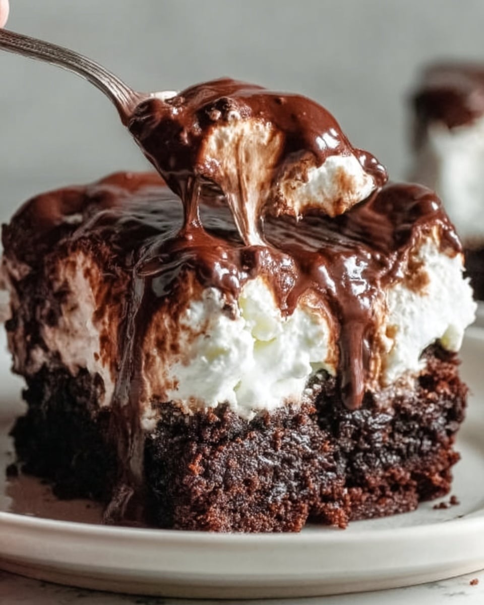 The image shows a close-up of a rich chocolate dessert with three layers. The bottom layer is a dark, moist brownie with a rough texture. On top of that is a white whipped cream layer that looks soft and fluffy, with some parts slightly melting into the brownie. The top layer is thick, glossy chocolate sauce drizzled unevenly, creating shiny waves that drip down the sides. A woman's hand holds a spoon taking a bite from the side of the dessert. The dessert is on a simple white plate with a white marbled surface background. Photo taken with an iphone --ar 4:5 --v 7