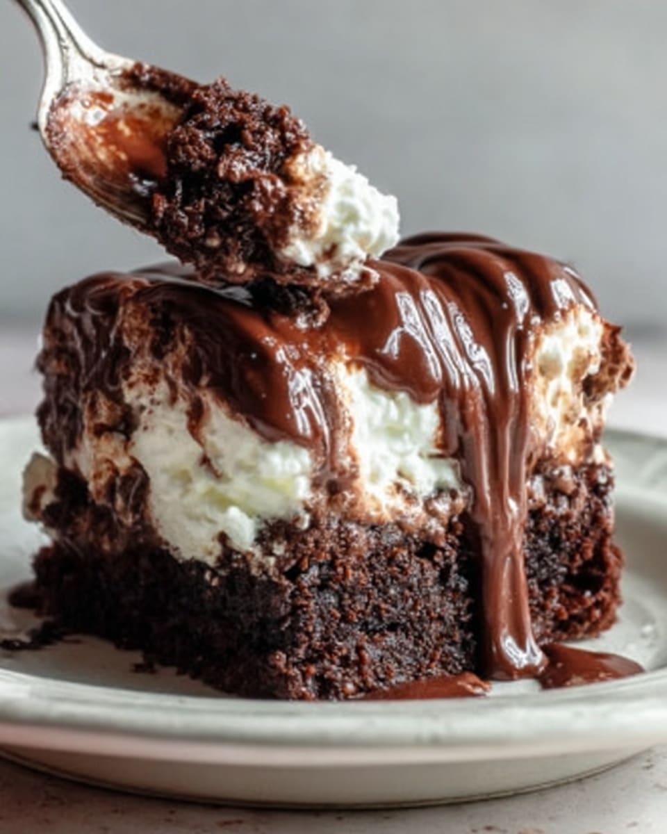The image shows a close-up of a rich chocolate dessert with three visible layers. The bottom layer is a dark, moist chocolate cake with a slightly crumbly texture. Above that is a thick layer of soft white whipped cream, fluffy and light in texture. The top layer is a shiny, smooth chocolate sauce that is dripping slightly down the sides, giving it a glossy and melted look. The dessert sits on a white plate over a white marbled surface. A woman's hand holding a fork is taking a bite from the dessert, showing a bit of the inside texture clearly. Photo taken with an iphone --ar 4:5 --v 7