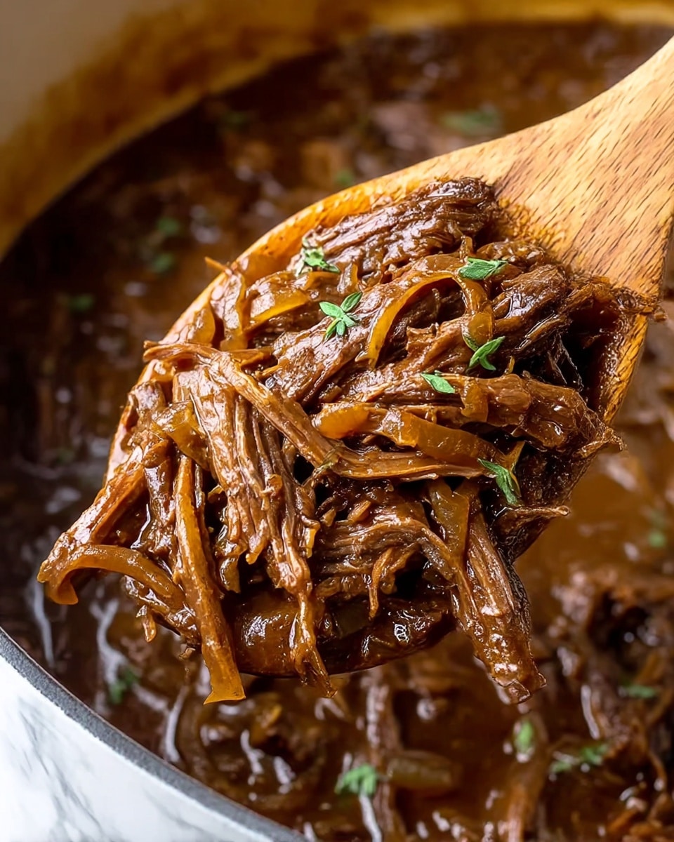 A close-up view of shredded beef cooked in a rich, dark brown sauce with visible soft, translucent cooked onions mixed in. The beef looks tender with fine fibrous layers, and small sprigs of fresh green herbs are scattered on top. The beef and sauce have a slight glossy texture, showing moisture and juiciness. A wooden spoon lifts a portion of the shredded meat from the pot, which also contains more beef and sauce in the blurred background. The overall scene is set against a white marbled texture. photo taken with an iphone --ar 4:5 --v 7