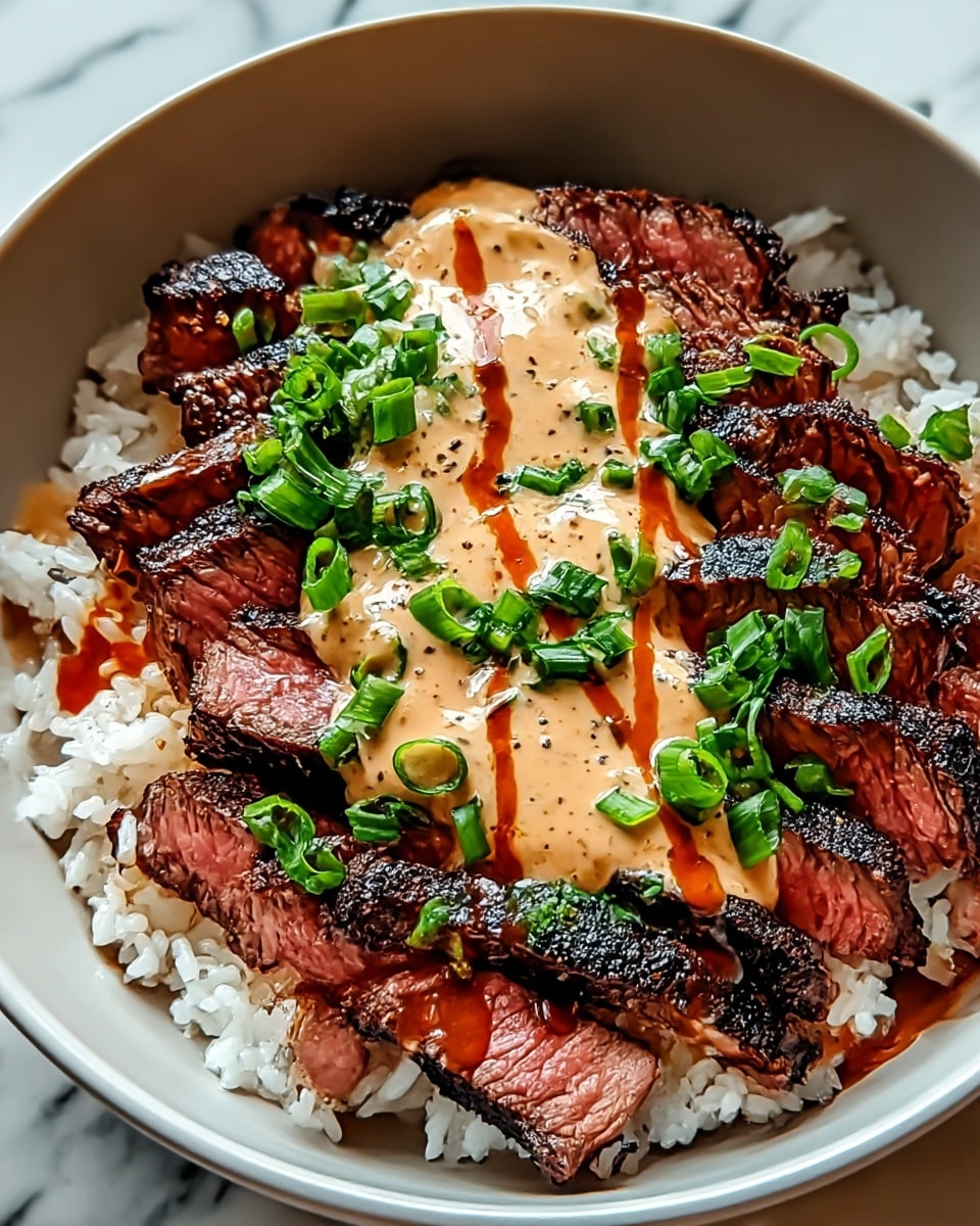 A black bowl filled with a base layer of white sticky rice, topped with evenly sliced pieces of grilled steak showing charred black edges and medium-rare pink centers. On top of the steak is a creamy light beige sauce drizzled with a thin layer of bright orange spicy sauce. The dish is finished with a generous sprinkle of fresh bright green chopped chives in the center. The bowl sits on a white marbled textured surface. photo taken with an iphone --ar 4:5 --v 7