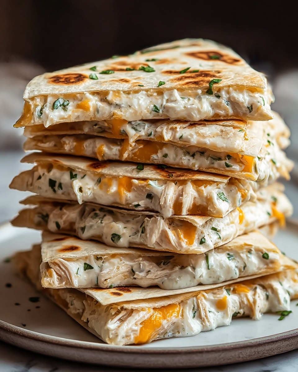 A stack of six folded quesadilla triangles filled with creamy white cheese mixed with green herbs and shredded chicken, along with small patches of melted orange cheese. Each quesadilla layer has a lightly toasted golden-brown flour tortilla with some darker brown grill marks and small green herb sprinkles on top. The whole stack sits on a round white plate against a soft white marbled background. The quesadilla filling is thick and slightly oozes out near the edges. photo taken with an iphone --ar 4:5 --v 7