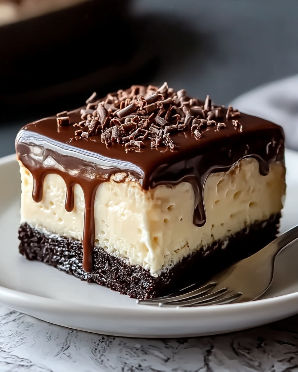 A close-up of a three-layer dessert on a white plate with a fork beside it; the bottom layer is a dark, dense chocolate cake with a moist texture, the middle layer is a thick, creamy light beige custard that slightly drips over the cake, and the top layer is a glossy, smooth dark chocolate ganache topped with small curled chocolate shavings. The dessert looks rich and shiny with the layers stacked neatly, set against a white marbled texture. Photo taken with an iphone --ar 4:5 --v 7